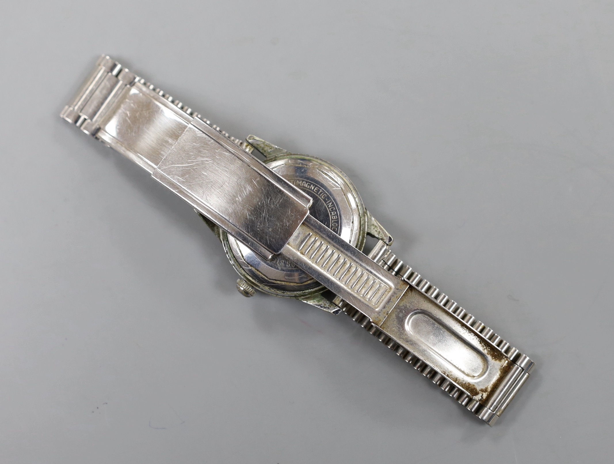 A gentleman's stainless steel backed Kendall and Dent Automatic Incabloc wrist watch, on associated steel bracelet.